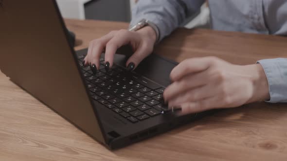 Closeup of a Girl's Hand Typing on a Laptop