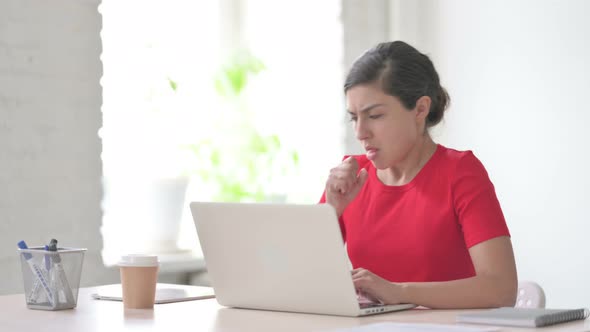 Indian Woman Coughing While Using Laptop in Office