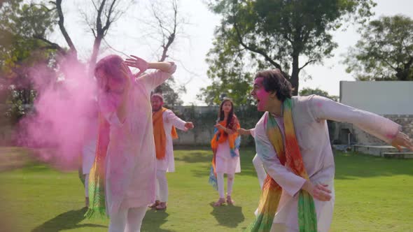 Indian man throws color on to his wife at a Holi party