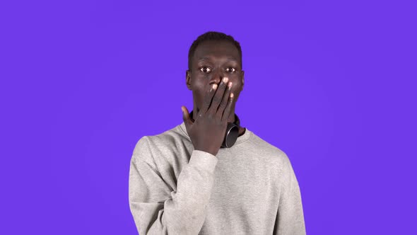 Cheerful Young African Man Gesturing in Respect to Someone