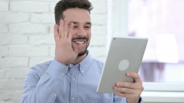 Video Chat on Tablet By Talking Young Man