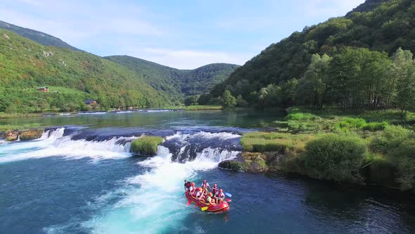 People rafting on waterfalls of Una river in Bosnia