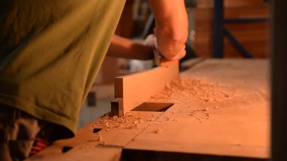 Carpenter Planing Wood in His Workshop in Slow Motion