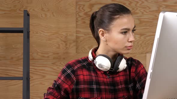 Young Beautiful Woman Listening To Music with Headphones