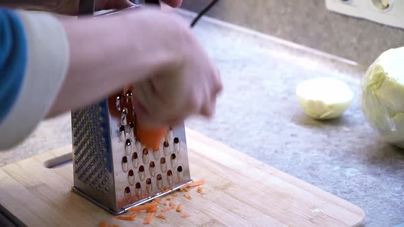 Woman Hands Grating Carrots