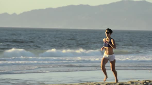 Woman running on the beach.