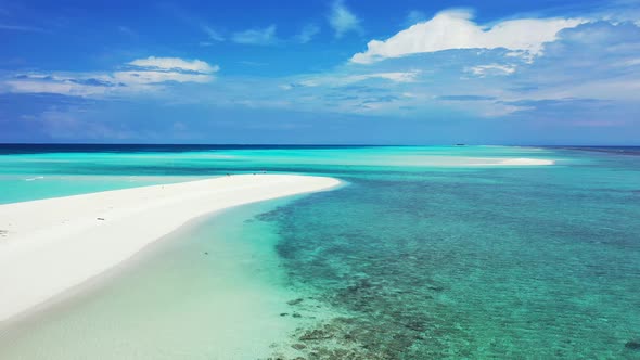 Natural flying tourism shot of a paradise sunny white sand beach and aqua turquoise water background