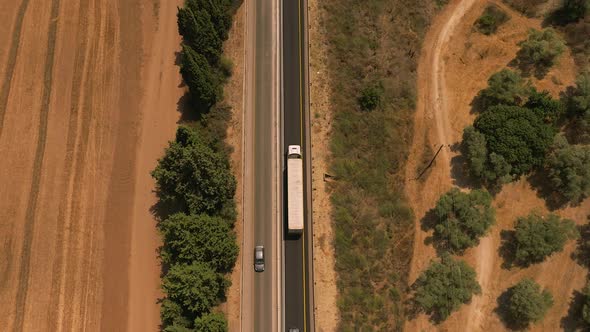 Truck loaded with Shipping container on a rural highway.