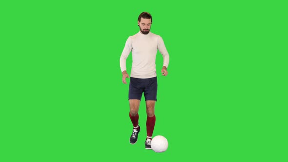 Football Player Walking with a Ball and Making a Pass on a Green Screen Chroma Key