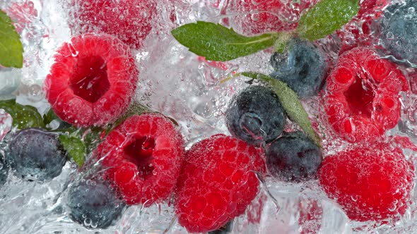 Super Slow Motion Shot of Pouring Water on Blueberries Raspberries and Ice Cubes at 1000 Fps