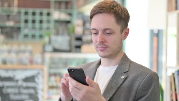 Portrait of Young Man Using Smartphone