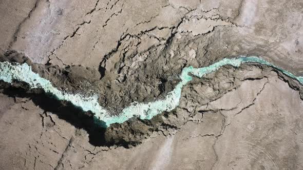 Dead Sea Hot Springs aerial top down shot fast zoom in over desert canyon landscape with crystal cle