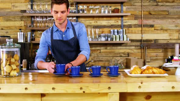 Portrait of waiter working at counter