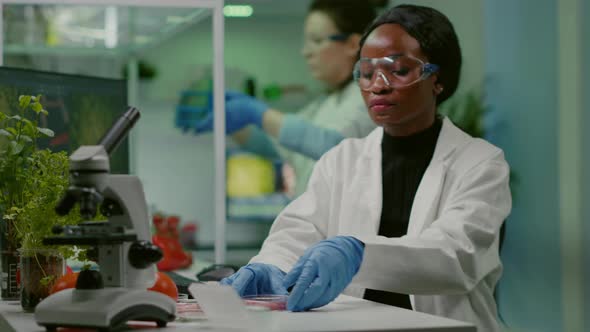 African Chemist Looking at Labgrown Vegan Meat Sample