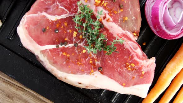 Marinated steak and ingredients on grill tray