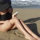 Young woman applying sun cream on beach - VideoHive Item for Sale