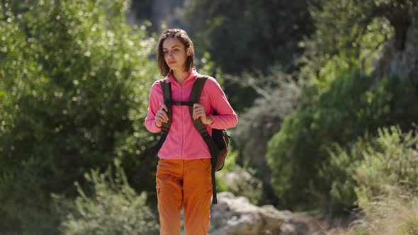 Camera Moving Around Attractive Walking Female Hiker Young Happy Woman Hiking Outdoors at Sunny Day