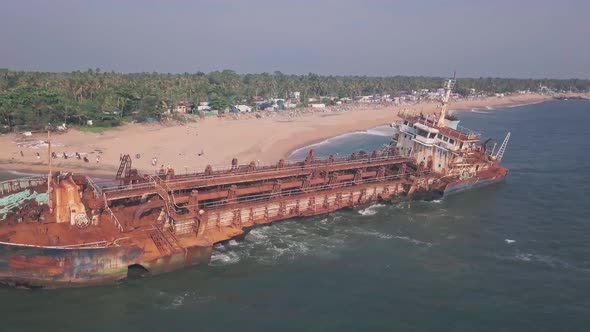 Old shipwreck on a beach near Varkala, Kerala, India. Aerial drone view