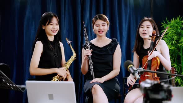 Classical band with girls Asian musicians are showing off their work online through social media.