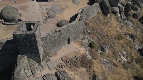 Defensive walls of ancient castle of Monsanto in Portugal. Aerial circling