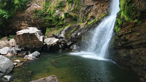 Nauyaca Waterfalls in Costa Rica, Rainforest Landscape Scenery of a Powerful Drop into a Pool, with