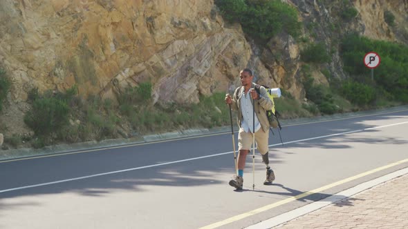 Sporty mixed race man with prosthetic leg hiking