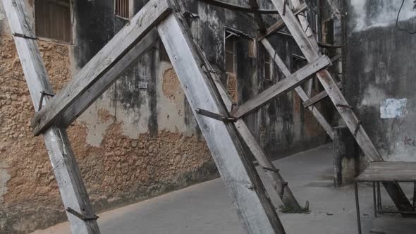Dilapidated Old Houses Supported By Wooden Beams in Stone Town Zanzibar Africa