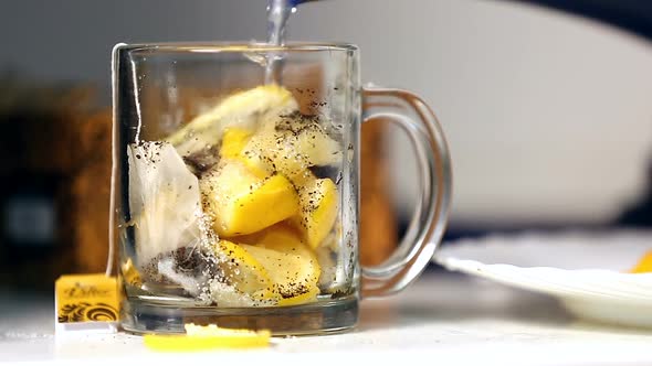 Tea and Many Lemons Being Poured Into Tea Cup