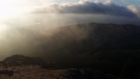 Mountains on foggy day with cloudy sky