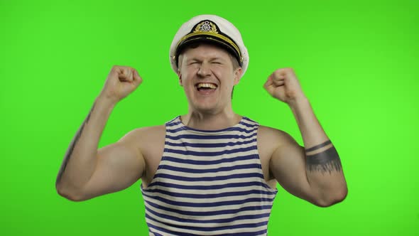 Young Sailor Man Celebrates Yelling Emotionally and Raises His Hands. Seaman Guy