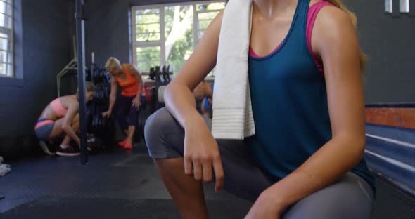 Woman resting after workout in gym