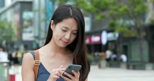 Woman Use of Mobile Phone in City