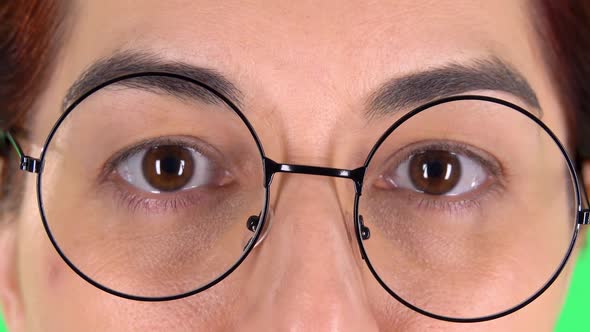 Female Eyes in Round Glasses Looking Straight and Smiling, Close Up