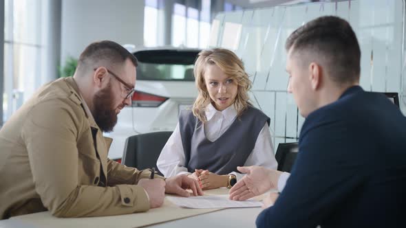 A Married Couple Signs a Contract for the Sale of a New Car