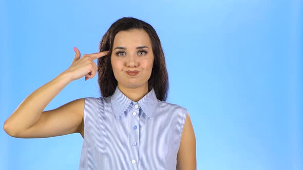 Female Putting Fingers To Her Temple Like Gun Feeling Tired