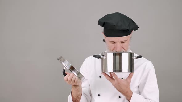 Professional Chef with a Pot on Grey Copy Space