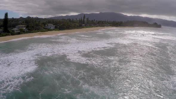 Aerial view of a man kitesurfing in Hawaii