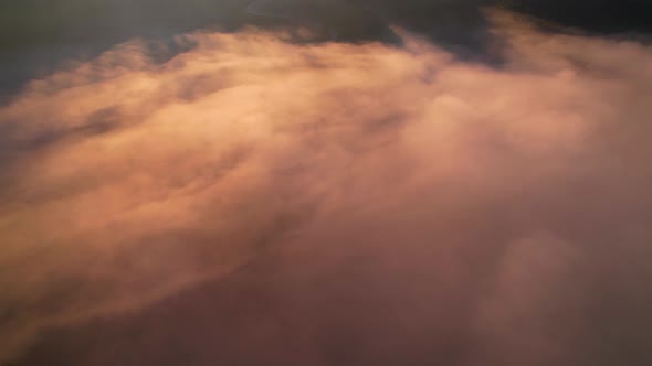 4K Drone Flying in the clouds. Flying through the clouds during sunrise