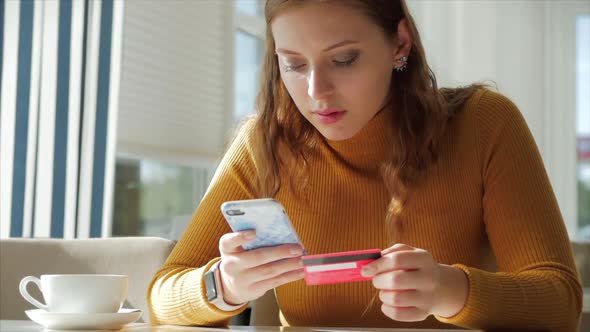 Beautiful Sunny Day Young Woman Drinks Morning Coffee in a Cafe, Making Online a Purchase Easy