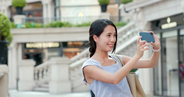 Woman taking photo on cellphone at outdoor