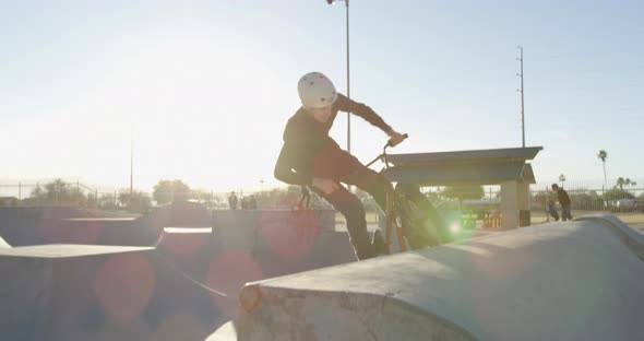 BMXer doing tricks in skatepark