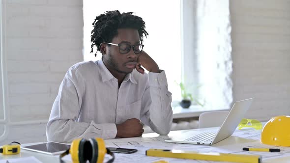 African Engineer Sleeping in Office 