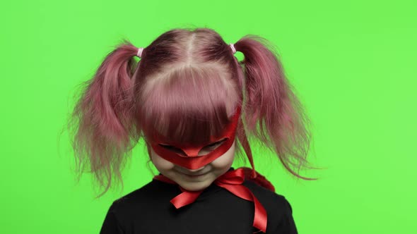 Funny Child Girl in Costume and Mask Plays Super Hero. National Superhero Day