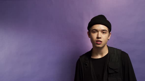 Portrait of a Young Guy on a Purple Background