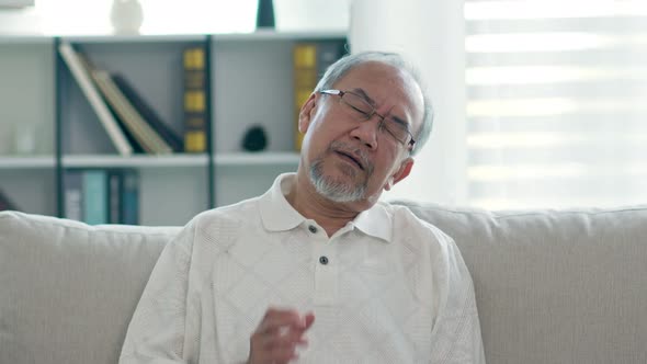 Asian Elderly senior man with white hairs neck and shoulder pain