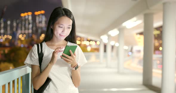 Young woman use of smart phone at night