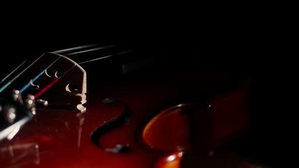 Violin Lies in the Darkness Illuminated By Light Closeup