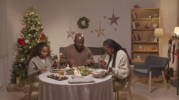 African-American Family of Three Enjoying Christmas Dinner