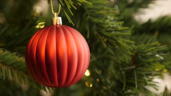 Close-up of Christmas ornament in  red color 4K 2160p 30fps UltraHD footage - Glass bauble on the ar