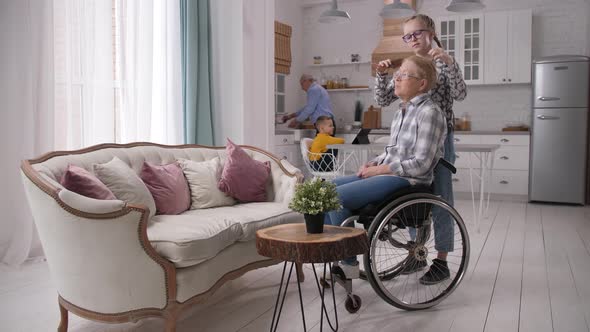 Loving Teen Granddaughter Combing Disabled Granny